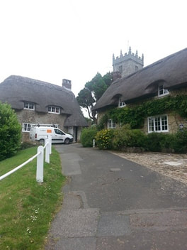 Church at thatched houses in Godshill