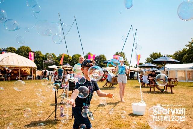 Child with bubbles at Isle of Wight Festival 2023