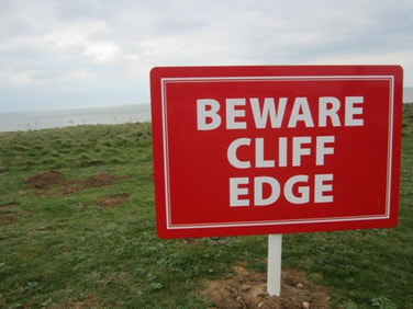Red sign saying Beware Cliff Edge