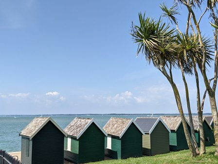 Green beach huts in Gurnard