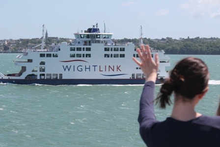 Woman waving at Wightlink ferry