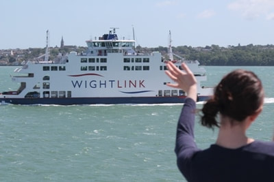 Person waving at a Wightlink ferry