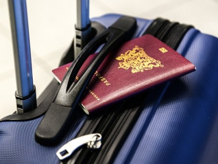 Passport on blue suitcase