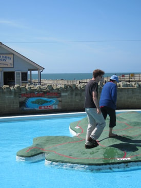 Two people walking on the Ventnor paddling pool